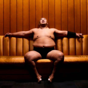 Sumo wrestler Byamba sitting on a couch