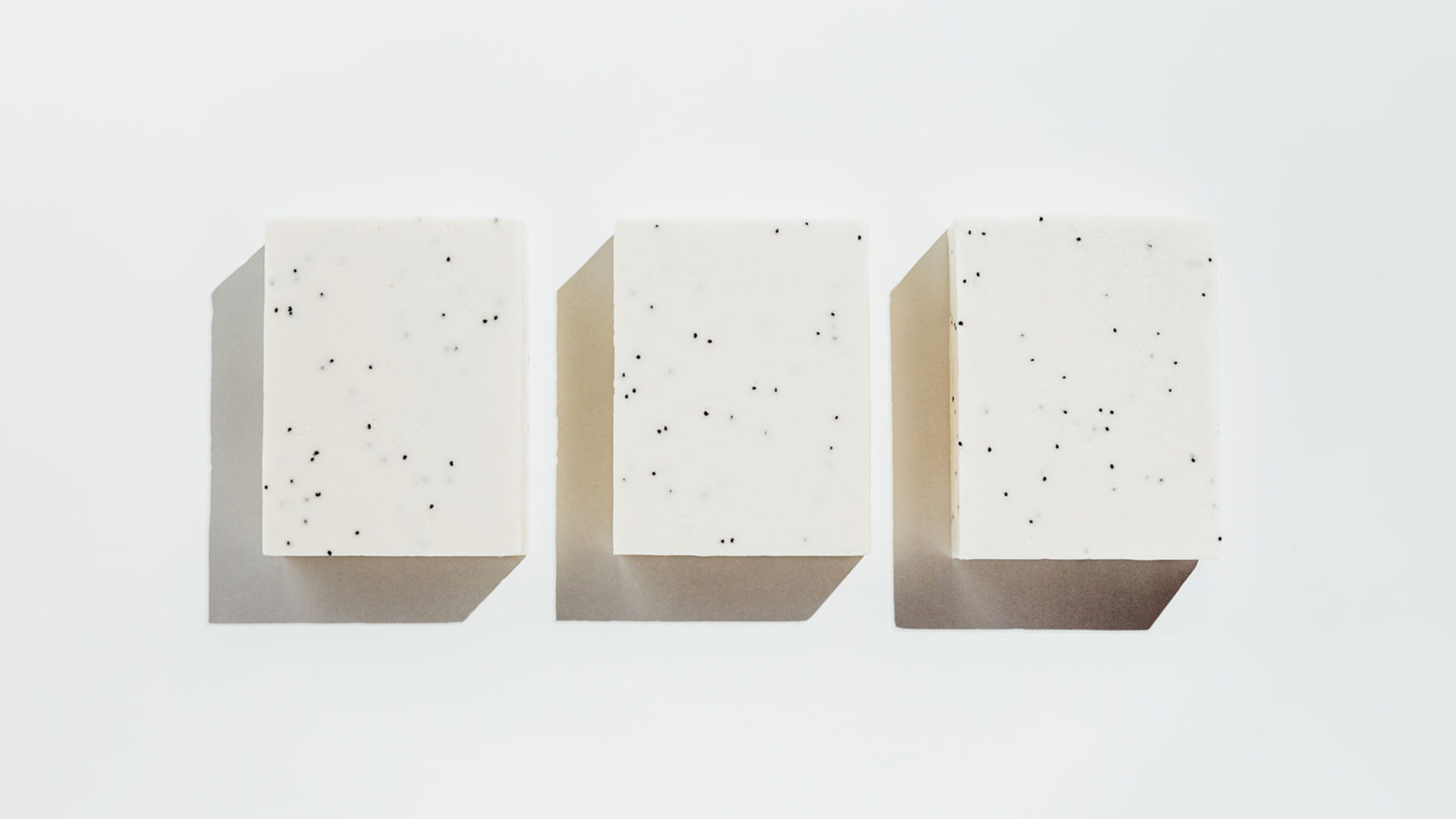 three blocks of white soap against a white background