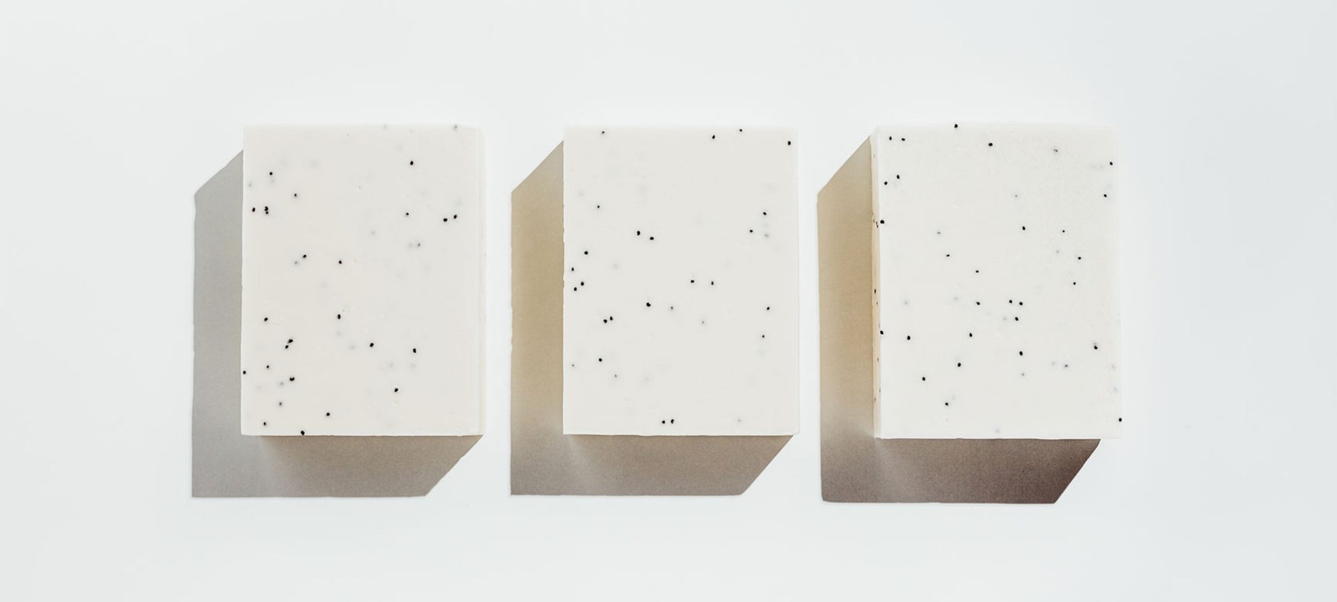 three blocks of white soap against a white background
