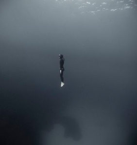 a free diver in the middle of the ocean