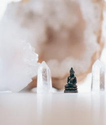 small buddha figurine within crystals