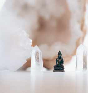 small buddha figurine within crystals