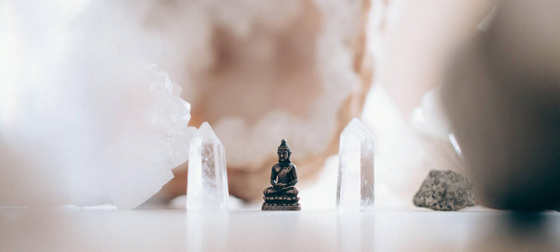 small buddha figurine within crystals