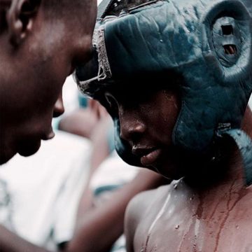 A young Bukom boxer with coach
