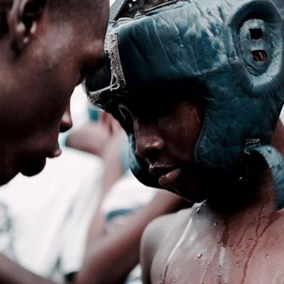 A young Bukom boxer with coach