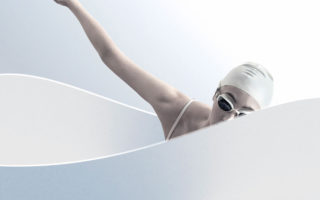 A female model poses as a swimmer in a white tub