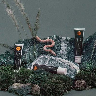 tubes of skincare with grass props