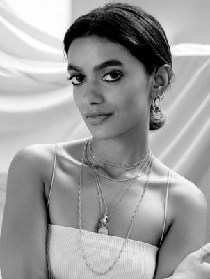 Stella Simona wears white top with gold jewellery