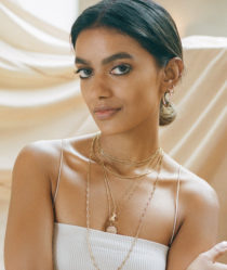 Stella Simona wearing white top and jewellery