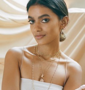 Stella Simona wearing white top and jewellery