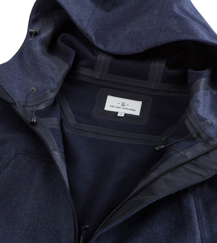 navy jacket open and showing the lost explorer label