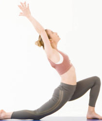 Model wears sports bra and green leggings in yoga pose