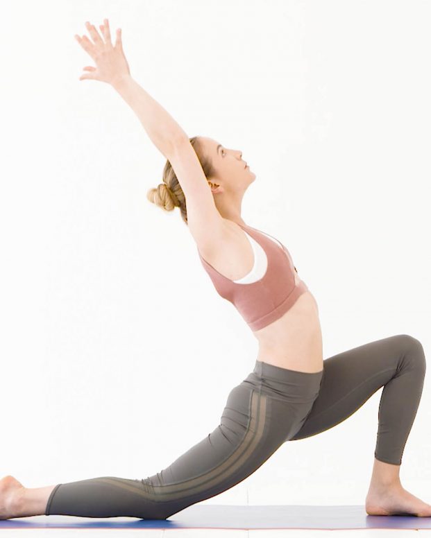 Model wears sports bra and green leggings in yoga pose