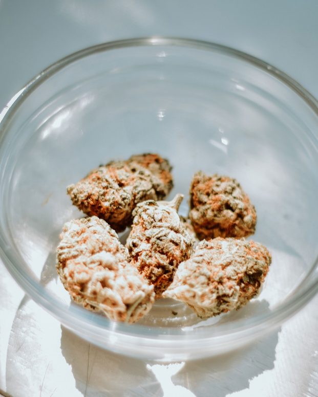 A few buds of kush in a clear bowl