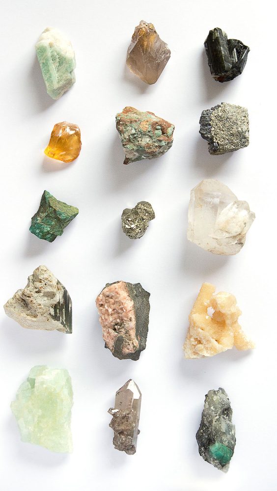 Rows of crystals and minerals against a white background