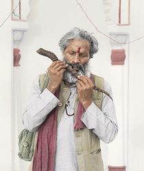An old Indian man plays on a wooden flute