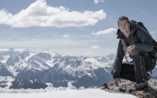 Adventurer Bear Grylls on top of a mountain