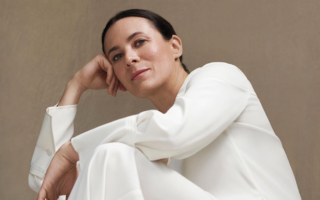style influencer garance dore poses with handbag for interview
