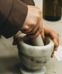 Hands working pestle and mortar