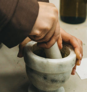 Hands working pestle and mortar