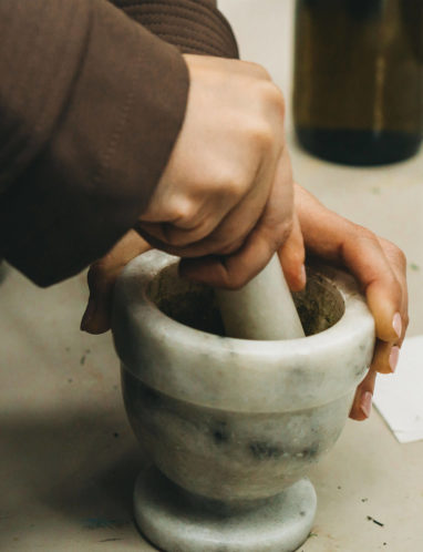 Hands working pestle and mortar
