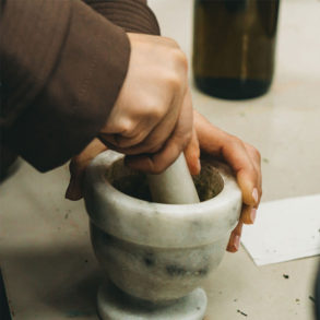 Hands working pestle and mortar