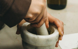Hands working pestle and mortar